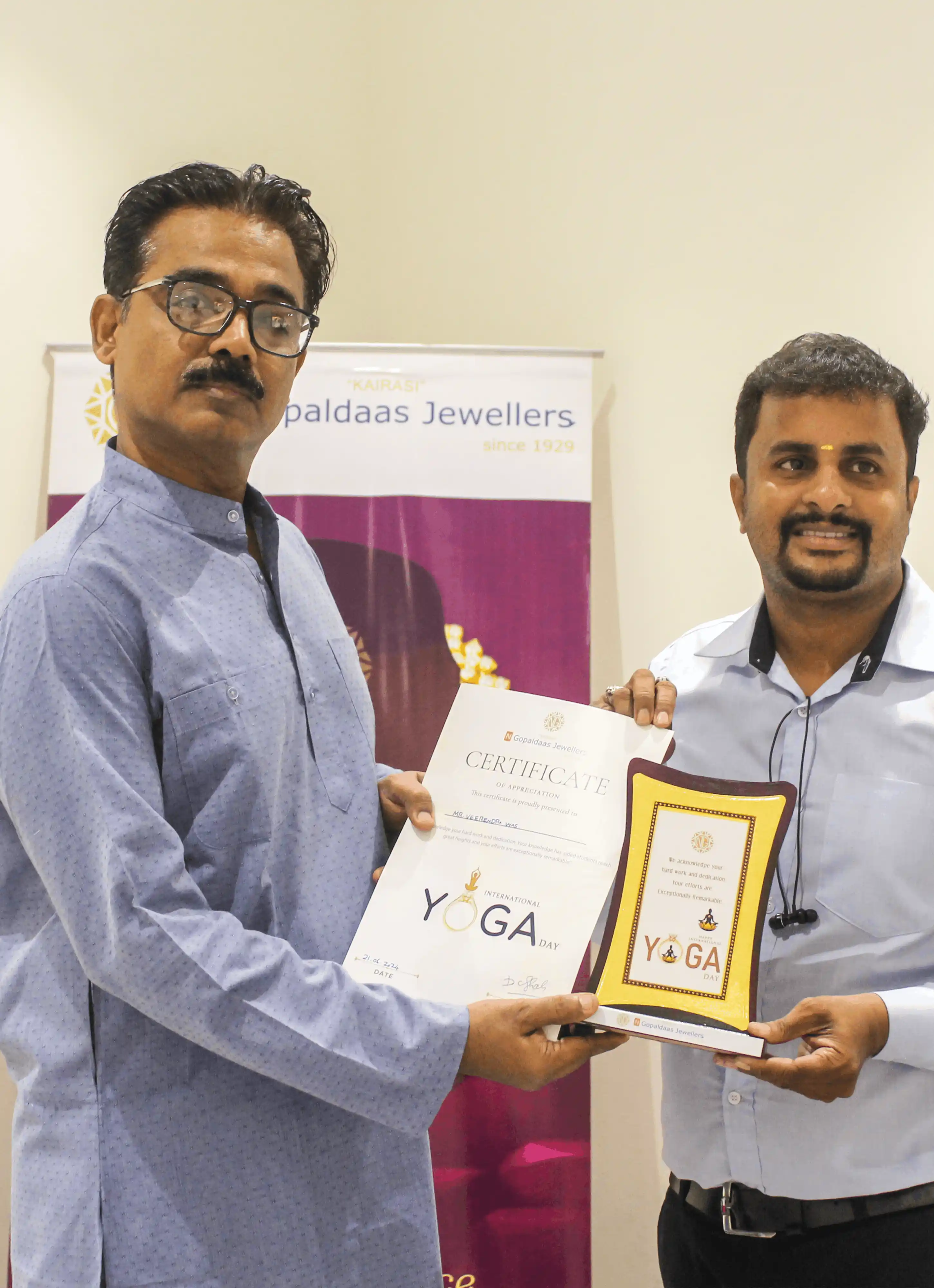Yoga student receiving an award certificate from the instructor